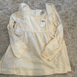 Adorable girls cream colored shirt with ruffle sleeve